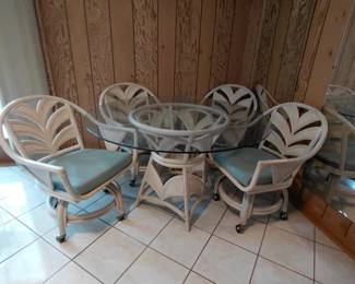 Rattan dining set with glass top table and four chairs