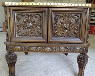 Ornate carved wood console cabinet with gilt finish