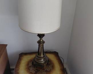 Brass table lamp on carved side cabinet