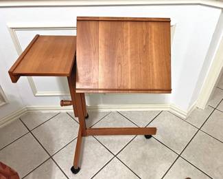 LEVENGER teak table showing how it can adjust
