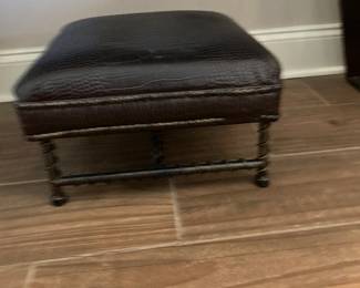 Leather upholstered footstool on wrapped metal base