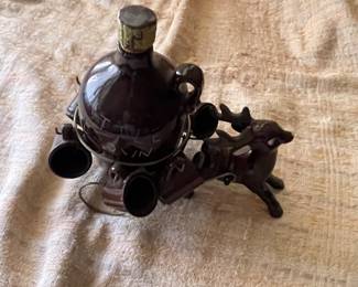 Deer with small shot glasses and bottle