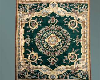 Deep green and ivory traditional rug featuring a prominent floral medallion and scrolling botanical motifs.
