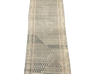 Long neutral runner featuring a softly faded geometric pattern in ivory, beige, pale blue, and gray.