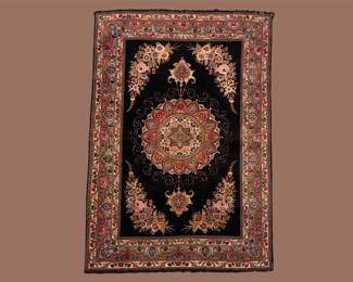 Dramatic black rug featuring a striking red and ivory circular medallion surrounded by floral detailing.