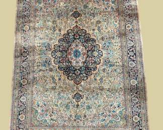 Soft ivory and muted blue traditional rug featuring an elaborate central medallion with delicate floral detailing.