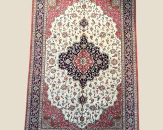 Ivory, burgundy, and blue traditional rug featuring an ornate central medallion and densely patterned floral field.
