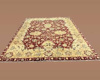 Ivory and burgundy rug featuring a dramatic floral medallion surrounded by scrolling botanical motifs.