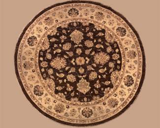 Round black, ivory, and gold rug featuring a dramatic floral medallion surrounded by elegant traditional detailing.