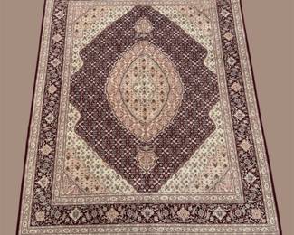 Soft ivory and mauve traditional rug featuring a large diamond-shaped central medallion surrounded by detailed ornamental patterns.