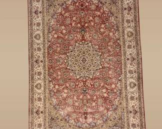 Soft rose and ivory traditional rug featuring an intricate central medallion and delicate surrounding floral detailing.