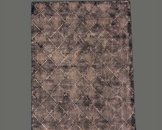 Soft blue and gray rug featuring a subtle repeating diamond pattern and gently distressed appearance.