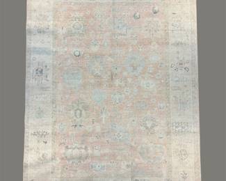 Pale ivory and light blue rug featuring an understated traditional pattern with softly faded coloration.