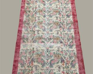 Soft distressed-style rug featuring muted ivory, gray, rose, and burgundy tones with a gently faded vintage-inspired appearance.