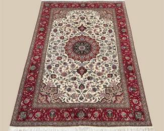 Ivory and burgundy traditional rug featuring an elaborate circular medallion surrounded by floral motifs and a rich red border.