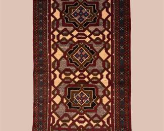Burgundy and ivory runner featuring bold geometric medallions and an intricate repeating border design.