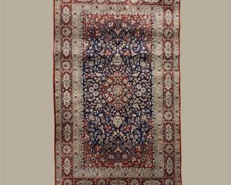 Burgundy, dark blue and beige colored rug with an intricate pattern and beautiful designs.