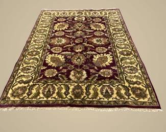 Black and gold traditional rug featuring repeating oval medallions surrounded by an intricate floral and geometric border.