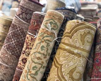 Rolled runners featuring classic patterns in warm neutral tones.