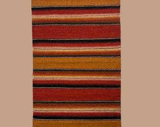 Bright multicolor striped runner featuring rich red, orange, blue, green, and gold horizontal bands.