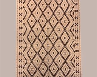 Ivory and black geometric rug featuring a clean repeating diamond pattern for a versatile transitional look.