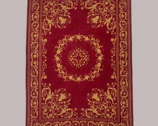 Rich burgundy and gold traditional rug featuring a large circular floral medallion surrounded by intricate scrolling details.
