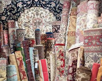 Warehouse view showcasing dozens of unique rugs and runners.