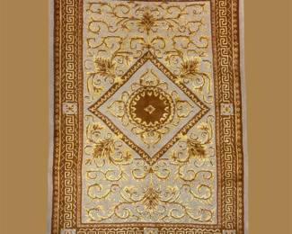 Ivory and gold traditional rug featuring a diamond-shaped central medallion surrounded by delicate scrolling details.