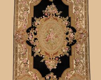 Dramatic black and gold traditional rug featuring an elaborate central medallion surrounded by ornate floral motifs.