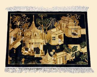 Black and gold pictorial rug featuring an intricate architectural landscape scene with buildings, trees, and decorative details.