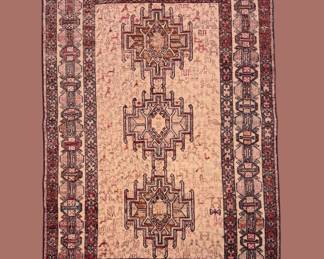Muted rose and ivory traditional rug featuring a detailed geometric central motif and multiple decorative borders.