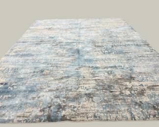Soft blue distressed-style rug featuring subtle abstract texture and gently faded coloration.
