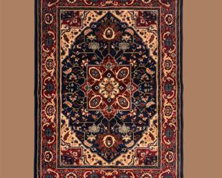 Navy, red, ivory, and gold rug featuring a bold geometric central medallion and richly detailed traditional border.