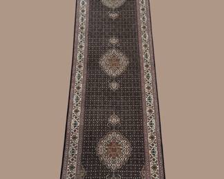 Long dark runner featuring repeating circular medallions and subtle floral detailing.