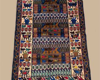 Dark woven rug featuring horizontal bands of intricate geometric patterns in navy, ivory, rust, and muted blue.