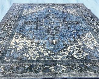 Blue and ivory traditional rug featuring a dense floral medallion pattern with intricate decorative detailing.