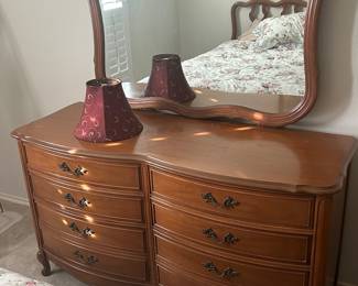Classic, vintage dresser with mirror. Red lampshade. 