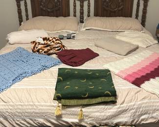 Classic king sized headboard with blankets and pillows 