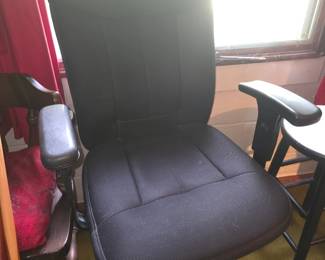Black fabric office chair with a padded mid-back design and adjustable T-arms.