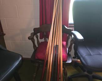 vintage one-piece wooden pool cue sticks, resembling classic house or bar cues from makers like Brunswick-Balke-Collender or similar traditional manufacturers