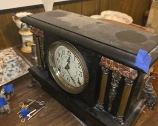 Sessions Clock Co. ebonized wood mantel clock with decorative bronze or brass columns and red faux-marble or stone accents, made in Forestville, Connecticut, during the early 1900s