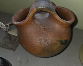 Navajo pine pitch pottery wedding vase featuring an embossed or carved corn motif and dual top-connected spouts/handles