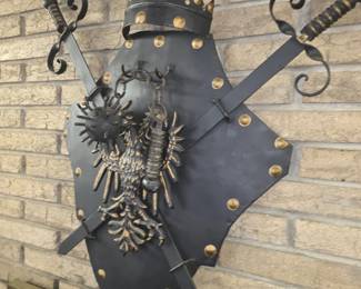 vintage medieval-style cast metal and iron wall-hanging set featuring an armorial shield topped with a crown, crossed swords, a double-headed eagle emblem, and a chained mace or ball-and-chain flail