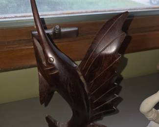 object is a vintage hand-carved wooden ironwood sailfish or swordfish figurine, commonly styled as a mid-century coastal or nautical folk art sculpture mounted on a natural wood base