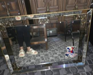 vintage beveled wall mirror with a mirrored and metallic-accented frame, resembling mid-century to Hollywood Regency-style decorative mirrors