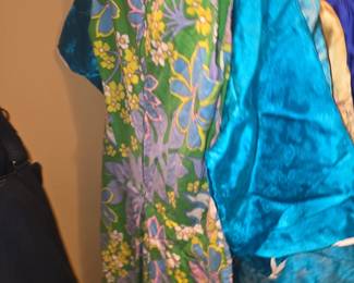 a vintage 1960s or 1970s floral print dress or tunic—likely featuring a bright green, blue, yellow, and periwinkle tropical pattern reminiscent of mid-century Hawaiian or retro mod fashion.