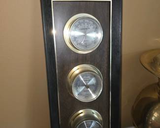 vintage Springfield Instrument Co. weather station (made in the USA), featuring a vertical faux-wood or wood-panel wall mount with a black and gold trim