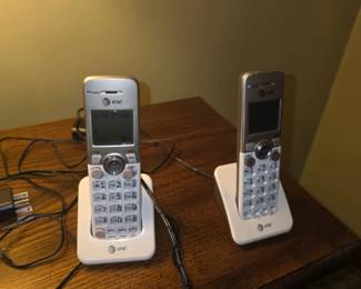 AT&T cordless phone handsets and charging cradles, closely resembling the AT&T EL52203 or EL52103 DECT 6.0 cordless phone system.