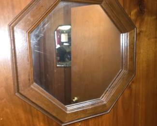 shows a vintage octagonal wall mirror with a beveled wood frame.