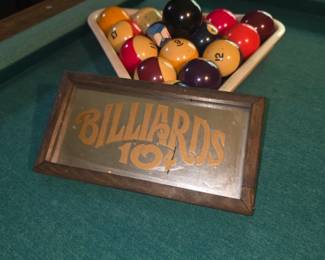 his is a vintage reverse-painted or mirrored "Billiards 10¢" sign in a wooden frame, typical of 1970s bar and game room deco